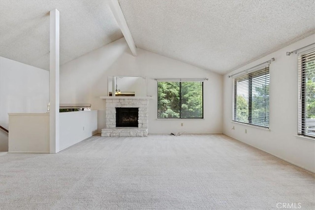 645 Worcester Dr, Cambria, CA 93428 - unfurnished living room featuring a textured ceiling, carpet floors, and a stone fireplace