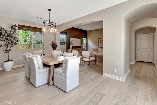 29310 Paseo Palmar, San Juan Capistrano, CA 92675 - dining area with arched walkways, light wood-type flooring, baseboards, and a chandelier