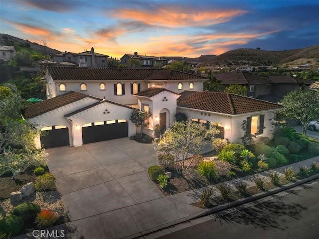 29310 Paseo Palmar, San Juan Capistrano, CA 92675 - mediterranean / spanish home with an attached garage, a tile roof, concrete driveway, stucco siding, and a residential view