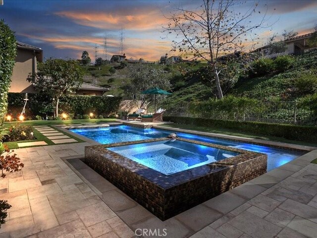 29310 Paseo Palmar, San Juan Capistrano, CA 92675 - pool at dusk with a patio, a fenced backyard, and a pool with connected hot tub