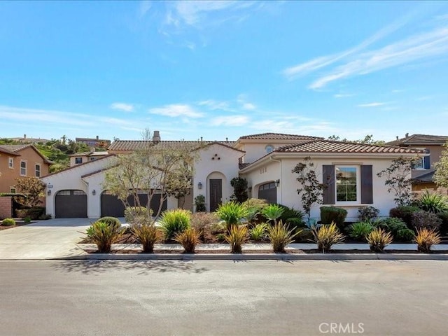 29310 Paseo Palmar, San Juan Capistrano, CA 92675 - mediterranean / spanish-style house with an attached garage, driveway, stucco siding, and a tile roof