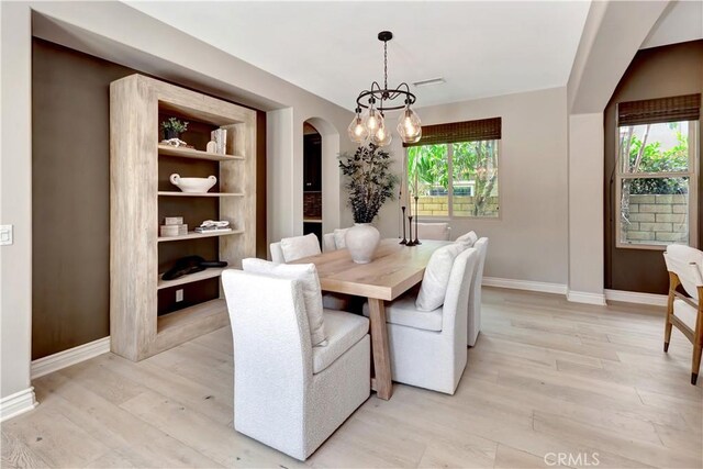 29310 Paseo Palmar, San Juan Capistrano, CA 92675 - dining room with arched walkways, baseboards, light wood-style flooring, and a chandelier