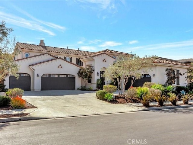 29310 Paseo Palmar, San Juan Capistrano, CA 92675 - mediterranean / spanish home featuring an attached garage, a chimney, driveway, and stucco siding