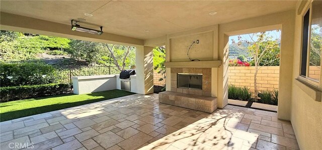 29310 Paseo Palmar, San Juan Capistrano, CA 92675 - view of patio / terrace with a tile fireplace and an outdoor kitchen