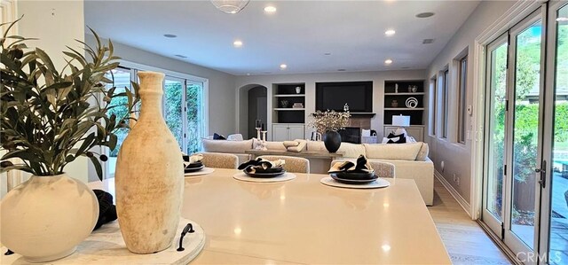 29310 Paseo Palmar, San Juan Capistrano, CA 92675 - living room with light wood finished floors, built in shelves, recessed lighting, arched walkways, and baseboards