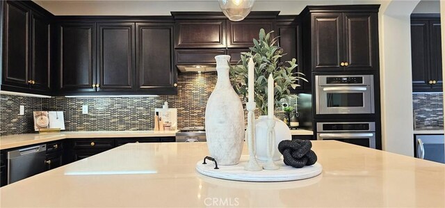 29310 Paseo Palmar, San Juan Capistrano, CA 92675 - kitchen featuring light countertops, appliances with stainless steel finishes, decorative backsplash, and arched walkways