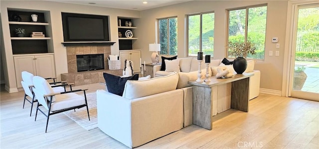 29310 Paseo Palmar, San Juan Capistrano, CA 92675 - living room with built in shelves, light wood-type flooring, a tiled fireplace, and recessed lighting