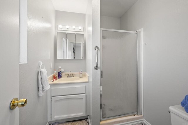 22432245 S Lanoitan, National City, CA 91950 - bathroom featuring vanity, a stall shower, and toilet