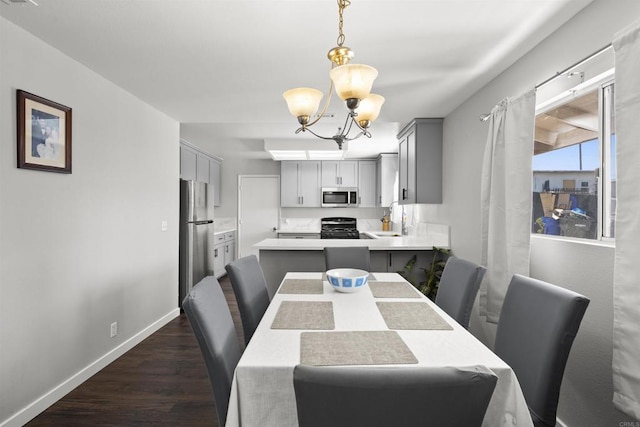 22432245 S Lanoitan, National City, CA 91950 - dining area featuring a chandelier, dark wood-style flooring, and baseboards