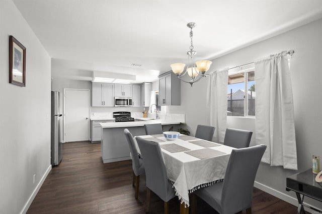 22432245 S Lanoitan, National City, CA 91950 - dining area with a chandelier, dark wood-style flooring, and baseboards