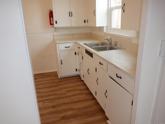 22432245 S Lanoitan, National City, CA 91950 - kitchen featuring a sink, light wood finished floors, white cabinets, light countertops, and baseboards