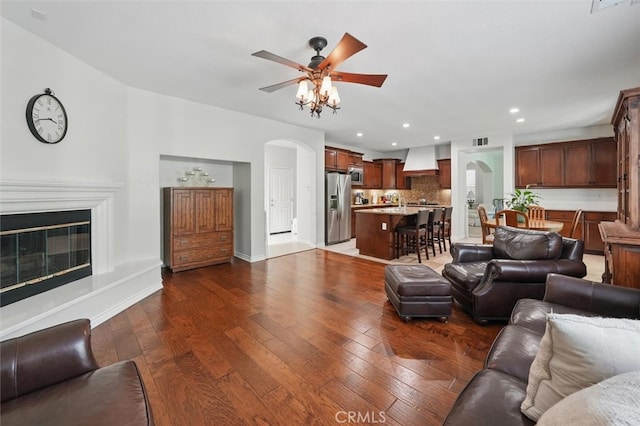 19728 Ellis Henry Ct, Newhall, CA 91321 - living area featuring a ceiling fan, arched walkways, recessed lighting, dark wood-type flooring, and baseboards