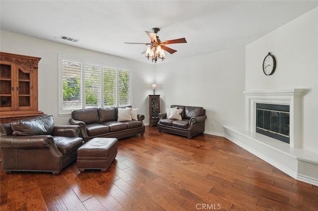 19728 Ellis Henry Ct, Newhall, CA 91321 - living area with dark wood-type flooring, a ceiling fan, and a glass covered fireplace
