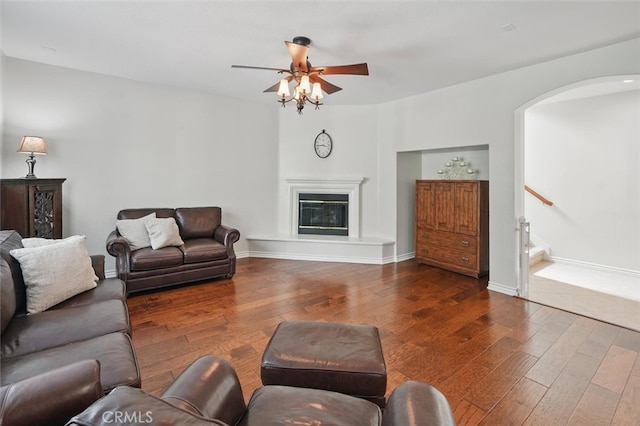 19728 Ellis Henry Ct, Newhall, CA 91321 - living room with arched walkways, hardwood / wood-style floors, a ceiling fan, a glass covered fireplace, and baseboards
