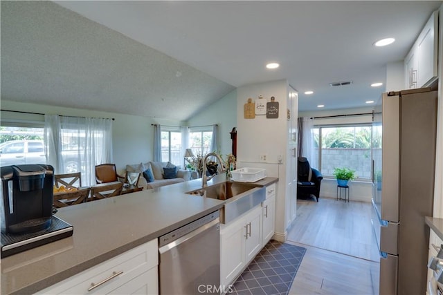 12076 Racket Ct, Moreno Valley, CA 92557 - kitchen featuring stainless steel appliances, a sink, healthy amount of natural light, white cabinetry, and recessed lighting