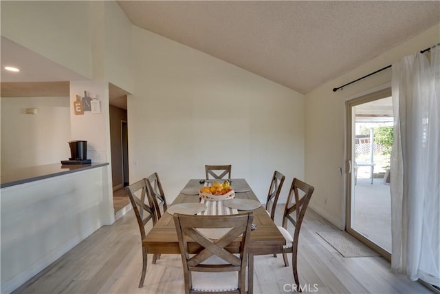 12076 Racket Ct, Moreno Valley, CA 92557 - dining space featuring lofted ceiling, light wood-style floors, and baseboards