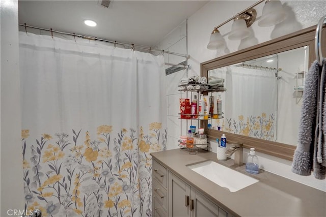 12076 Racket Ct, Moreno Valley, CA 92557 - bathroom featuring vanity, a shower with shower curtain, and recessed lighting