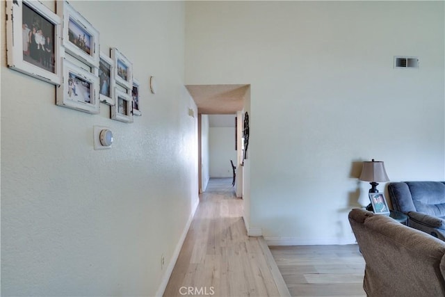 12076 Racket Ct, Moreno Valley, CA 92557 - hallway with light wood finished floors and baseboards