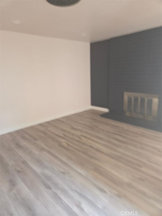 1512 Forane, Barstow, CA 92311 - unfurnished living room featuring a fireplace and wood finished floors