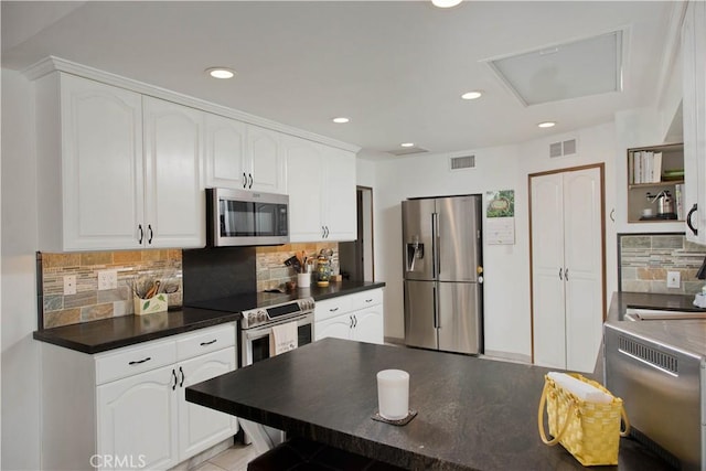 23328 Valley Circle Blvd, Chatsworth, CA 91311 - kitchen featuring appliances with stainless steel finishes, dark countertops, white cabinetry, and recessed lighting