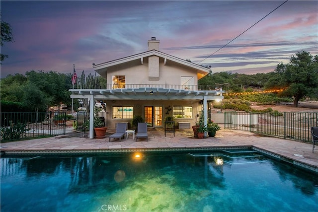 23328 Valley Circle Blvd, Chatsworth, CA 91311 - back of property at dusk with a patio, a pergola, a chimney, and french doors