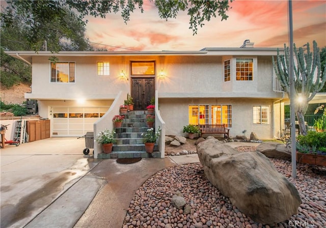 23328 Valley Circle Blvd, Chatsworth, CA 91311 - view of front of property with stucco siding, a garage, and concrete driveway