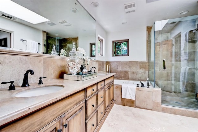 2917 N Poinsettia Ave, Manhattan Beach, CA 90266 - bathroom with double vanity, a bath, a stall shower, and tasteful backsplash