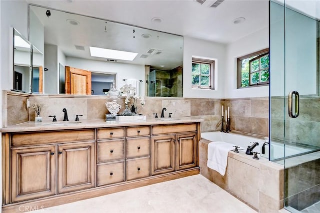 2917 N Poinsettia Ave, Manhattan Beach, CA 90266 - full bathroom featuring a skylight, double vanity, a garden tub, a stall shower, and backsplash