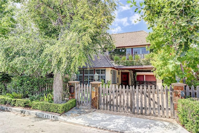 2917 N Poinsettia Ave, Manhattan Beach, CA 90266 - tudor home with a gate, a fenced front yard, stucco siding, a tile roof, and a balcony