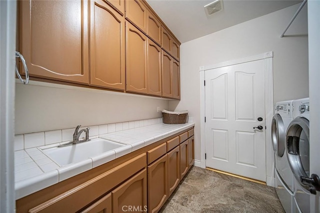 1459 W Quince Ct, Ontario, CA 91762 - laundry room with cabinet space, washer / dryer, and light stone finish floors