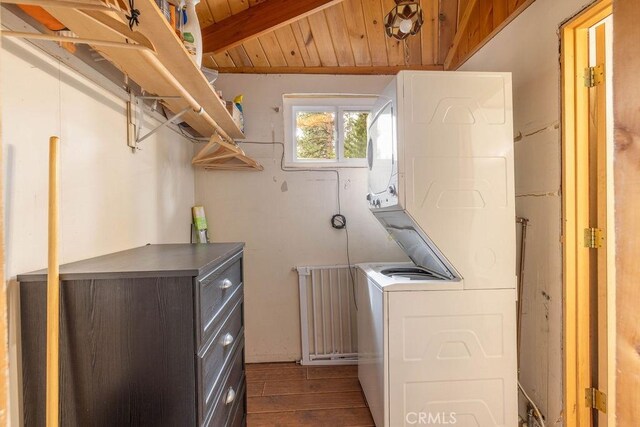 43387 Sheephorn Rd, Big Bear Lake, CA 92315 - washroom featuring stacked washer and clothes dryer, dark wood finished floors, and wooden ceiling
