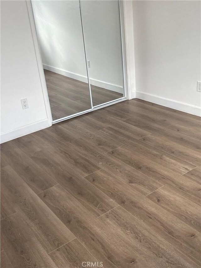 1442 W 220th St, Torrance, CA 90501 - unfurnished bedroom with wood finished floors, baseboards, and a closet