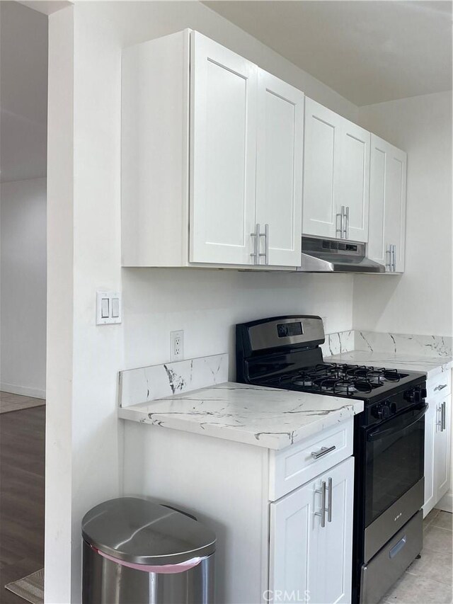 1442 W 220th St, Torrance, CA 90501 - kitchen featuring gas stove, under cabinet range hood, white cabinets, and light stone counters