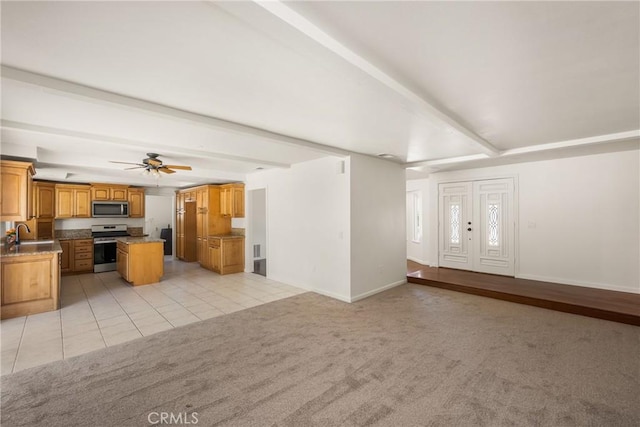 16481 Valle Vista Way, Riverside, CA 92506 - unfurnished living room with light colored carpet, baseboards, a ceiling fan, light tile patterned floors, and a sink