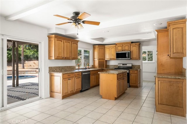 16481 Valle Vista Way, Riverside, CA 92506 - kitchen featuring appliances with stainless steel finishes, a kitchen island, light tile patterned floors, light stone countertops, and recessed lighting
