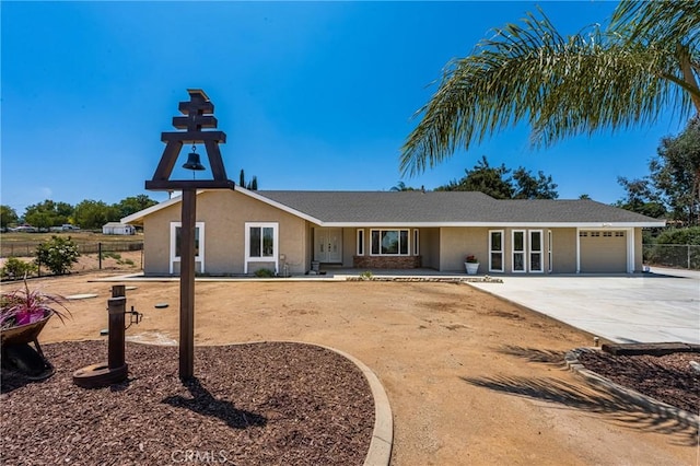 16481 Valle Vista Way, Riverside, CA 92506 - view of front facade with an attached garage, driveway, and stucco siding