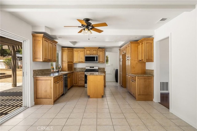 16481 Valle Vista Way, Riverside, CA 92506 - kitchen featuring stainless steel appliances, a kitchen island, light tile patterned floors, and light stone countertops
