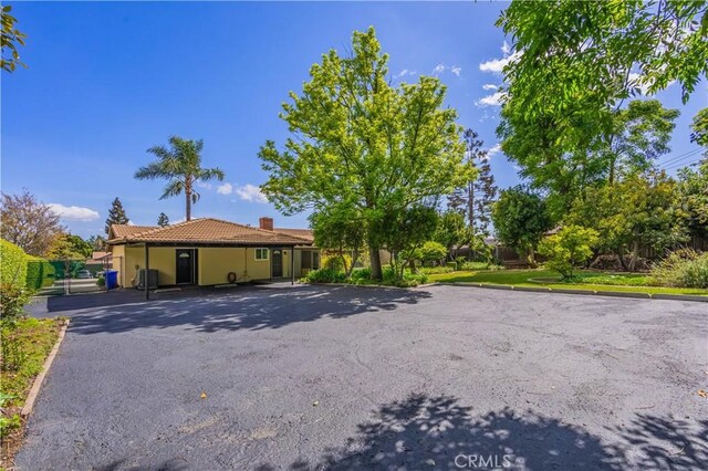 2445 Ocean View Dr, Upland, CA 91784 - single story home with uncovered parking, a tile roof, a chimney, and stucco siding