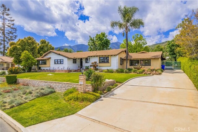 2445 Ocean View Dr, Upland, CA 91784 - single story home with a mountain view, concrete driveway, and a front yard