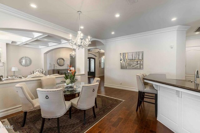 3007 Springbank Ct, Bakersfield, CA 93311 - dining area with arched walkways, dark wood-style flooring, ornamental molding, recessed lighting, and baseboards