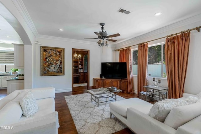 3007 Springbank Ct, Bakersfield, CA 93311 - living area featuring a ceiling fan, crown molding, dark wood finished floors, arched walkways, and baseboards