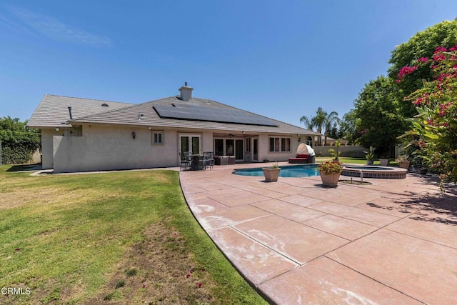 3007 Springbank Ct, Bakersfield, CA 93311 - back of house featuring a lawn, roof mounted solar panels, french doors, a patio, and stucco siding