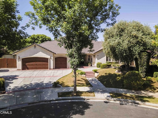 3007 Springbank Ct, Bakersfield, CA 93311 - view of front of property with concrete driveway, an attached garage, stucco siding, and a tiled roof