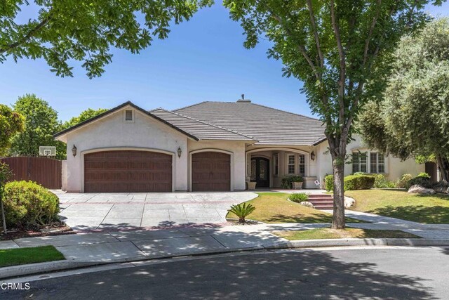 3007 Springbank Ct, Bakersfield, CA 93311 - french provincial home with stucco siding, an attached garage, and driveway