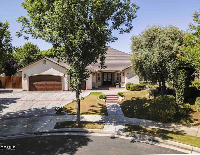 3007 Springbank Ct, Bakersfield, CA 93311 - obstructed view of property with concrete driveway, stucco siding, an attached garage, and a tile roof