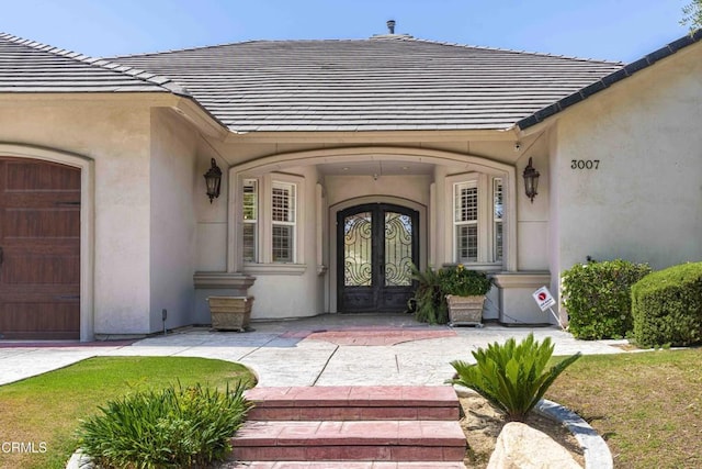 3007 Springbank Ct, Bakersfield, CA 93311 - view of exterior entry featuring french doors, stucco siding, a tile roof, and an attached garage