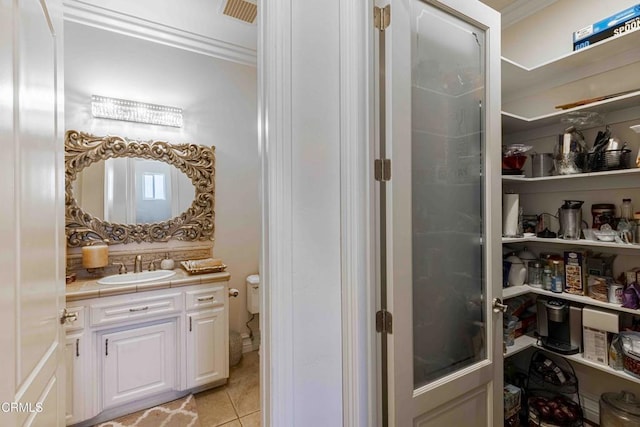 3007 Springbank Ct, Bakersfield, CA 93311 - bathroom with vanity, tile patterned floors, ornamental molding, toilet, and tasteful backsplash