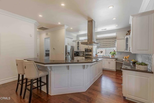 3007 Springbank Ct, Bakersfield, CA 93311 - kitchen featuring crown molding, stainless steel refrigerator with ice dispenser, island exhaust hood, glass insert cabinets, and a kitchen breakfast bar