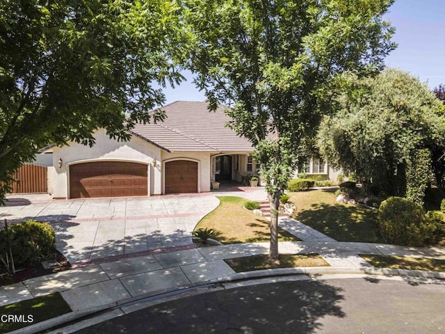 3007 Springbank Ct, Bakersfield, CA 93311 - obstructed view of property featuring a garage, driveway, stucco siding, and a tile roof