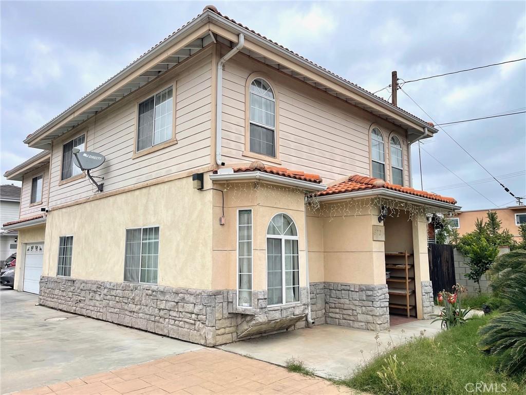 3717 Durfee Ave, El Monte, CA 91732 - rear view of property featuring stone siding, stucco siding, a garage, and concrete driveway